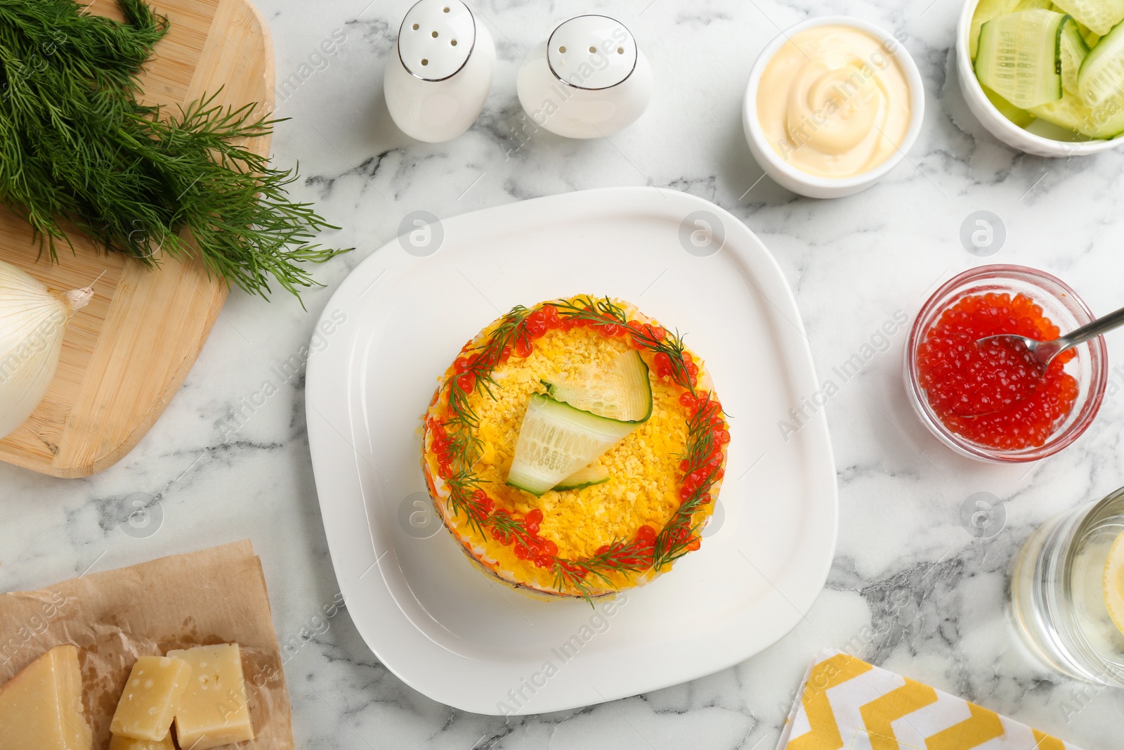 Photo of Traditional russian salad Mimosa served on white marble table, flat lay