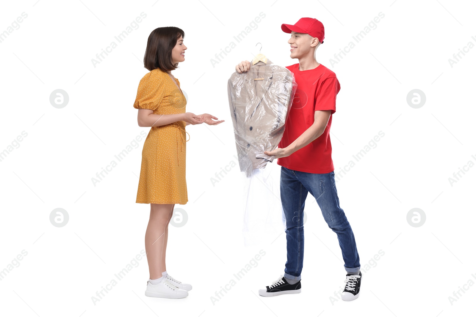 Image of Dry-cleaning delivery. Courier giving jacket in plastic bag to woman on white background