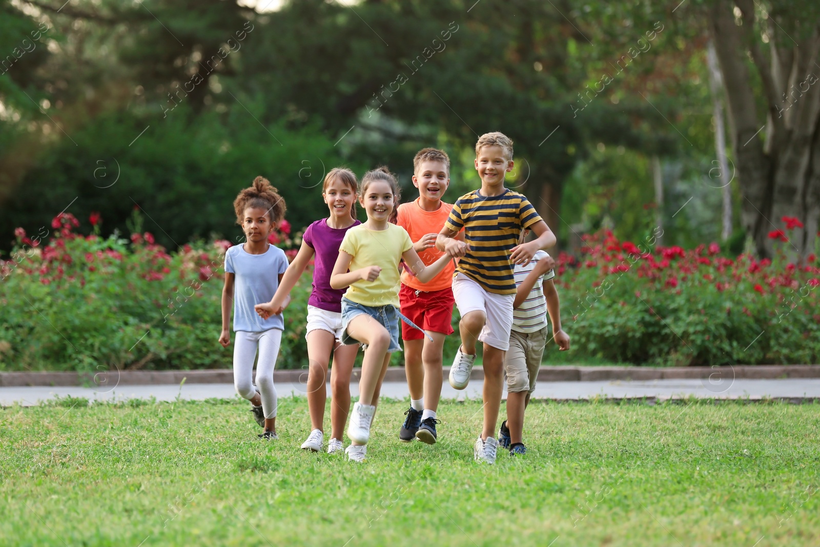Photo of Cute smiling little children playing in park
