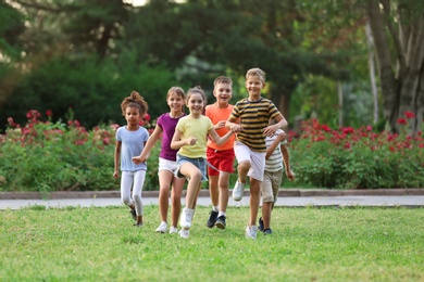 Photo of Cute smiling little children playing in park