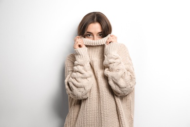 Photo of Beautiful young woman in warm sweater on white background