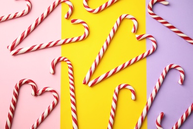 Photo of Flat lay composition with candy canes on color background