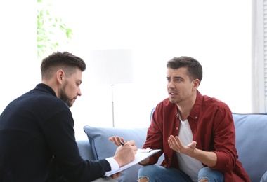 Male psychologist with client in office