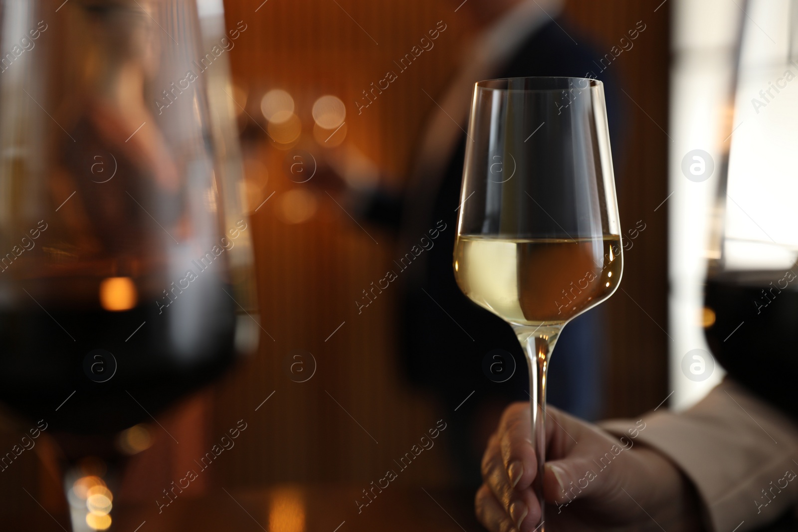 Photo of Woman with glass of wine in restaurant, closeup. Space for text