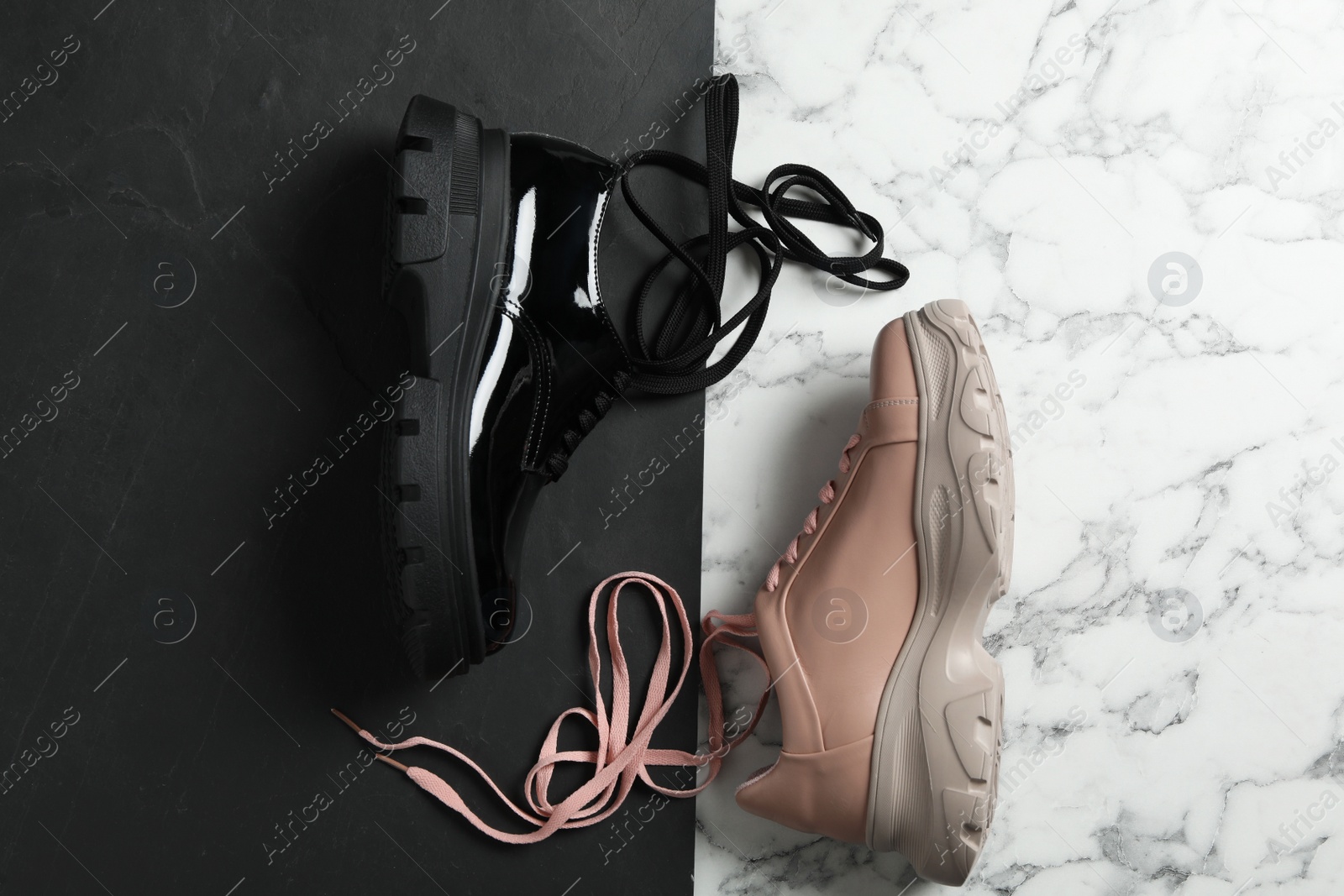 Photo of Stylish shoes with laces on color background, flat lay