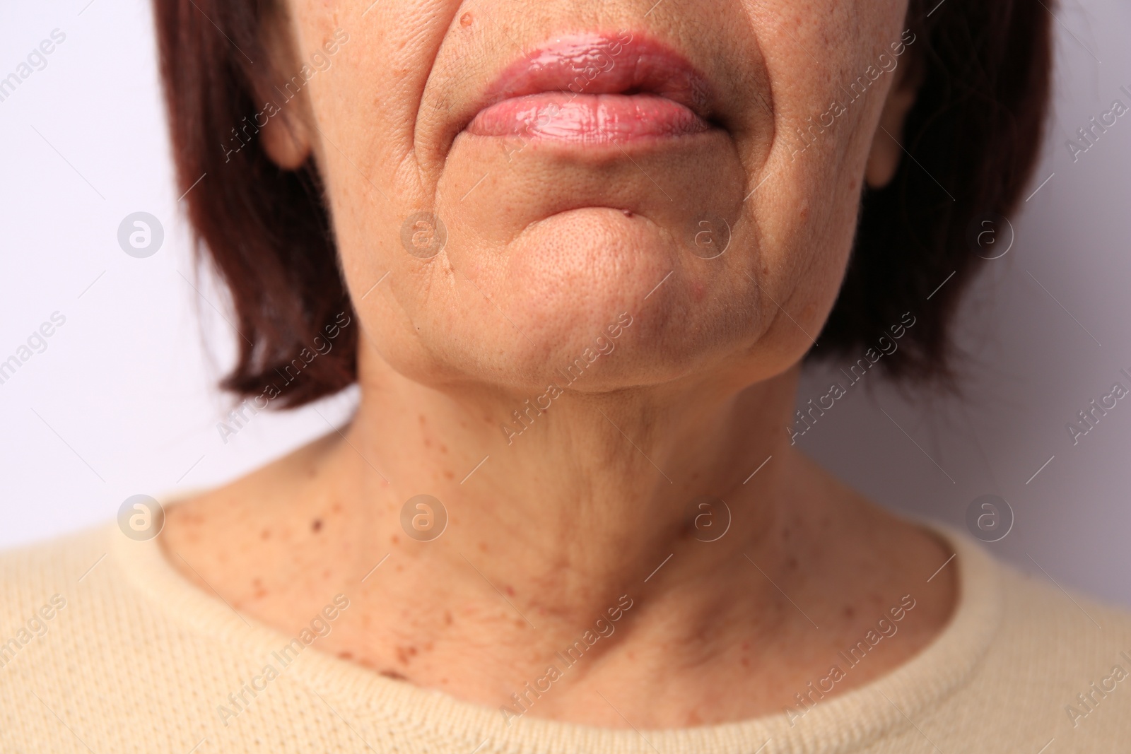 Photo of Closeup view of older woman on white background