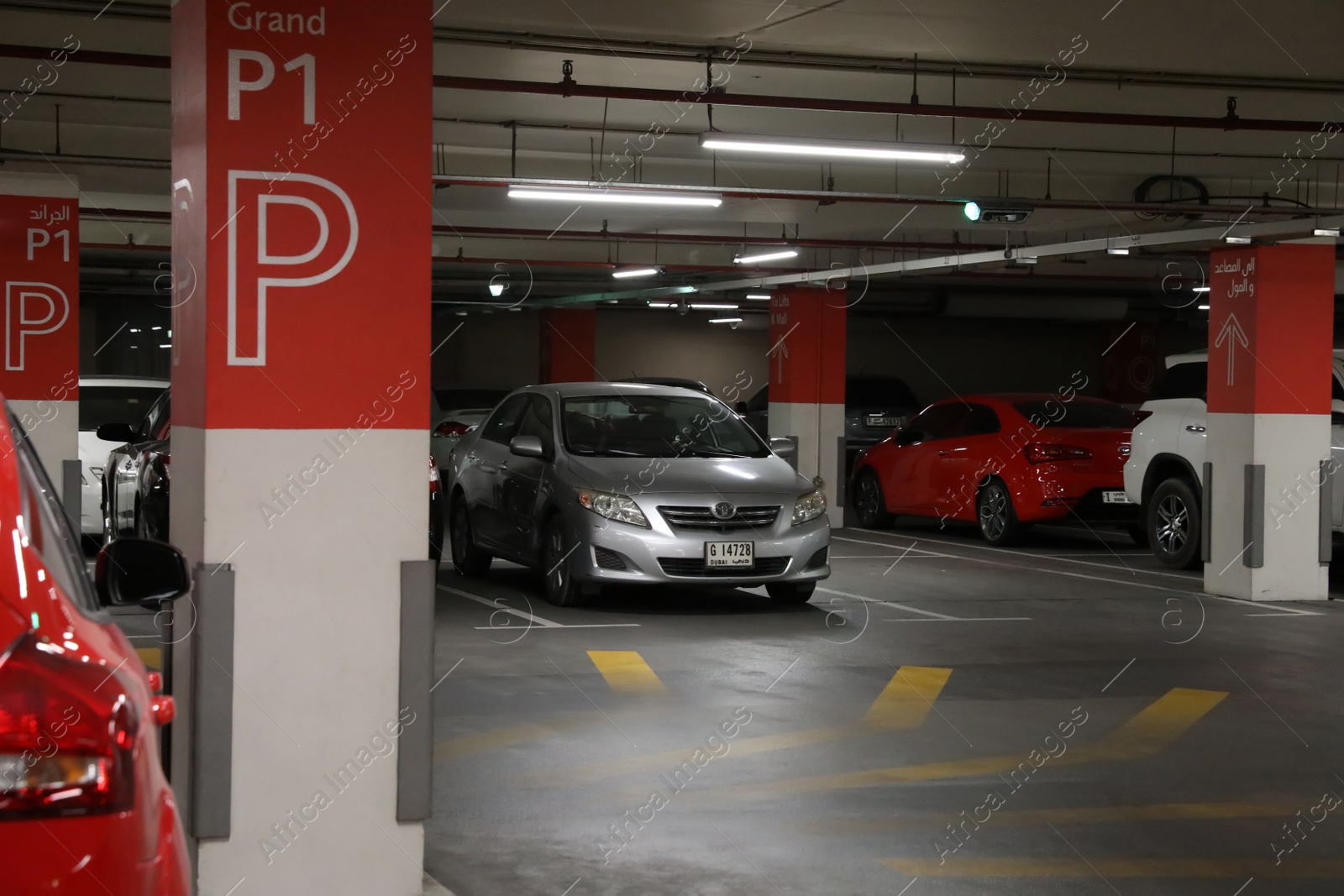 Photo of DUBAI, UNITED ARAB EMIRATES - NOVEMBER 04, 2018: Modern underground parking garage with different cars