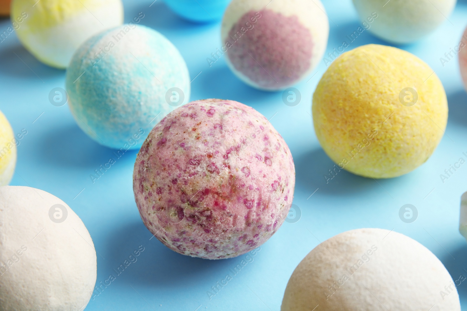 Photo of Many different bath bombs on color background