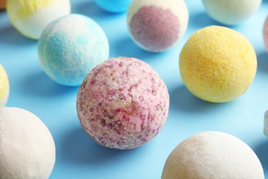 Photo of Many different bath bombs on color background