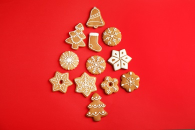 Photo of Christmas tree shape made of tasty homemade cookies on color background, top view