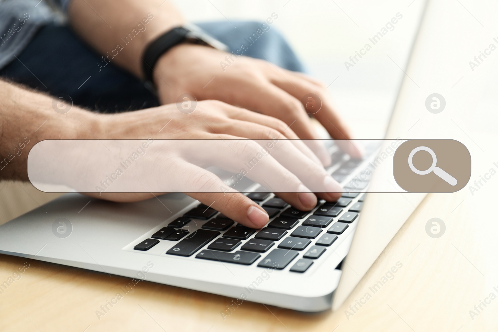 Image of Search bar of internet browser and man working on modern laptop at table indoors, closeup