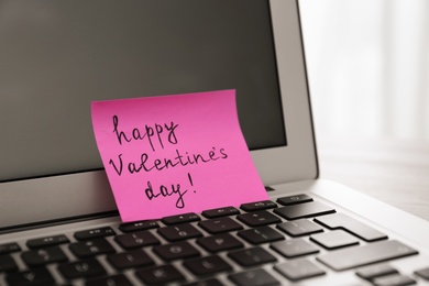 Photo of Memory sticker with phrase Happy Valentine's Day on laptop, closeup