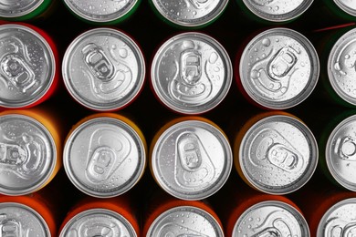 Photo of Energy drinks in wet cans, top view. Functional beverage