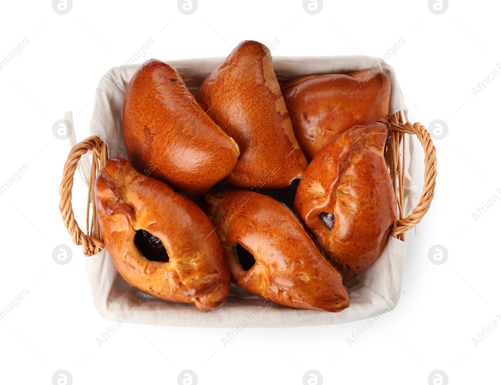 Photo of Wicker basket with delicious baked patties on white background, top view