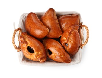 Wicker basket with delicious baked patties on white background, top view