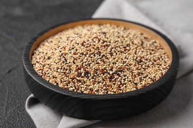 Photo of Plate with mixed quinoa seeds on grey background