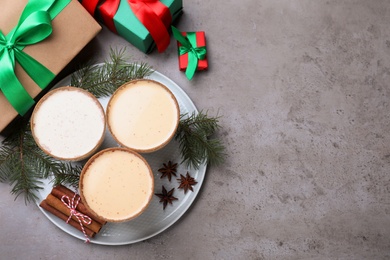 Photo of Delicious Christmas liqueur on grey table, flat lay. Space for text