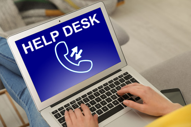 Image of Young woman calling to help desk service with laptop indoors, closeup. 