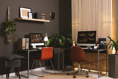 Photo of Cozy workspace with computer on metal desk at home