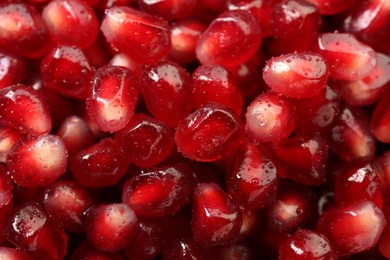 Photo of Ripe juicy pomegranate grains with water drops as background, top view