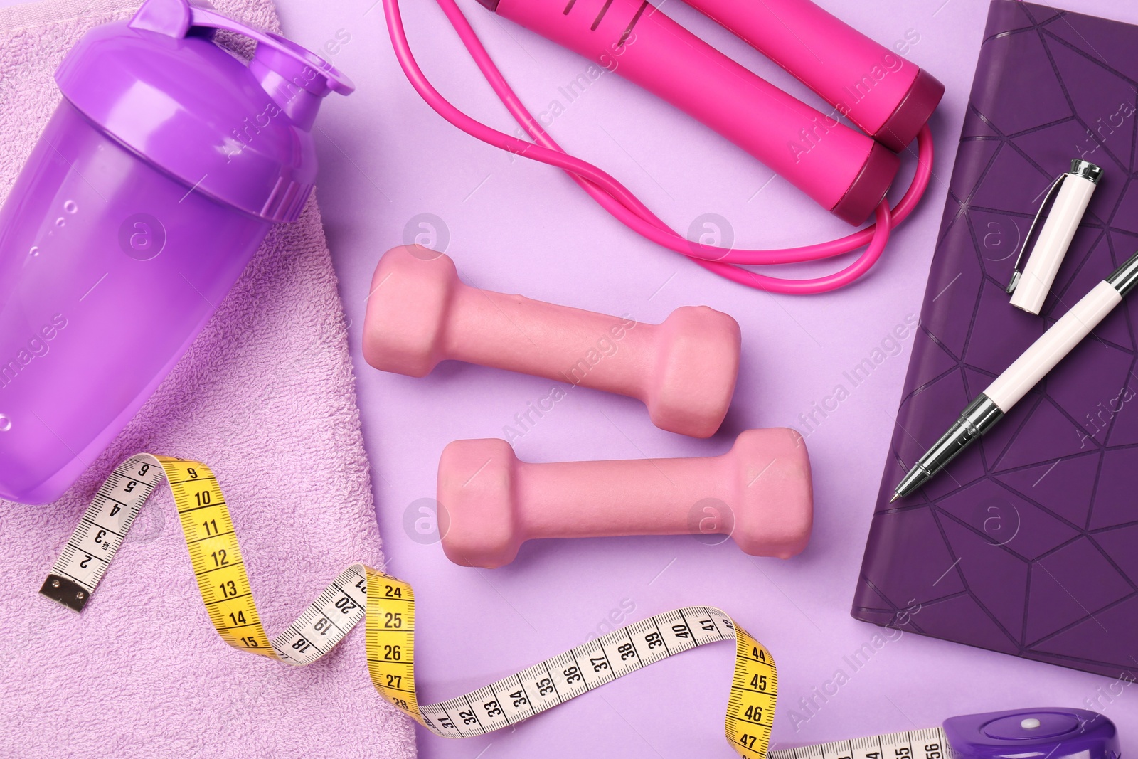 Photo of Flat lay composition with dumbbells on violet background