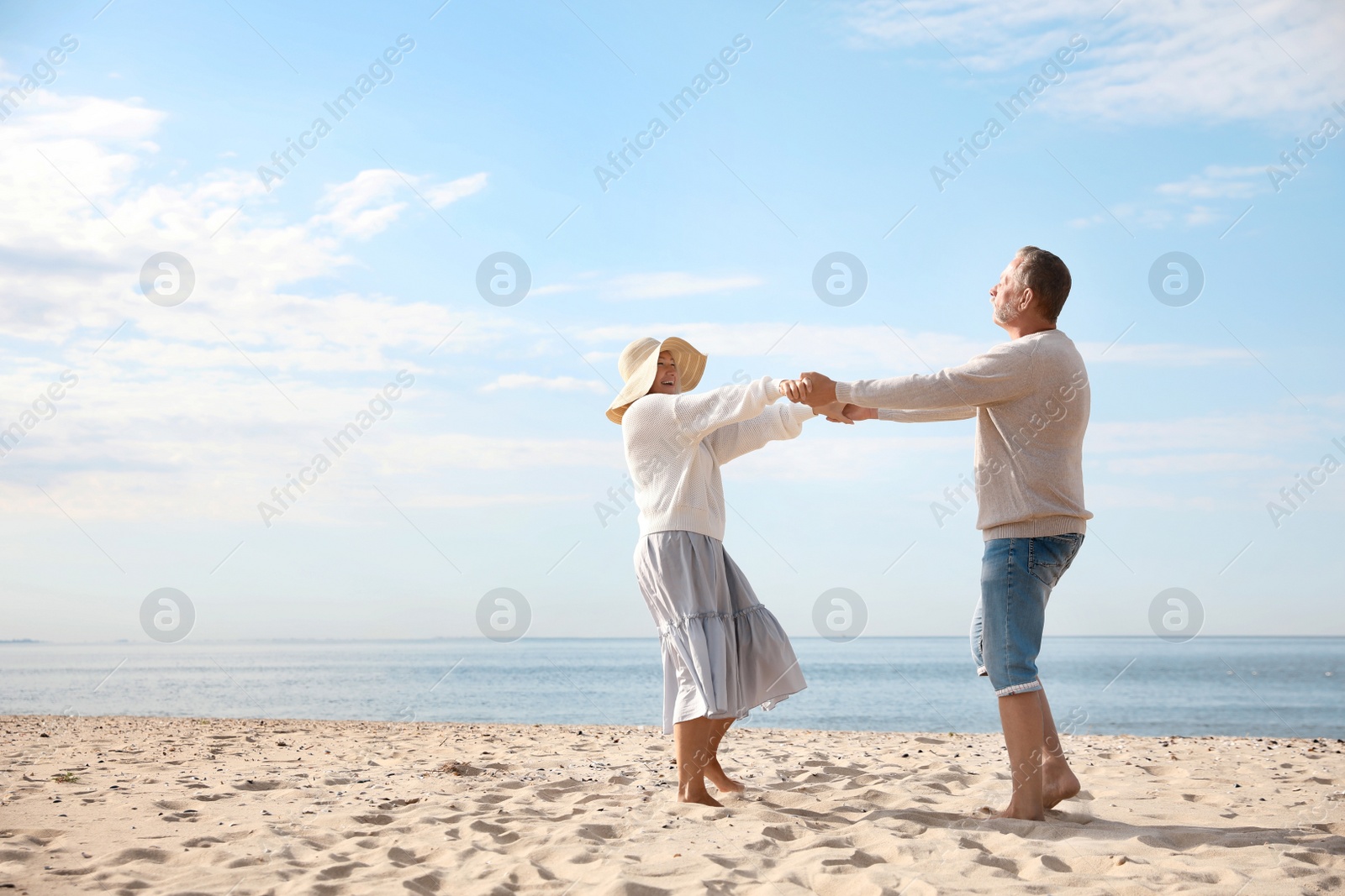 Photo of Mature couple spending time together on sea beach