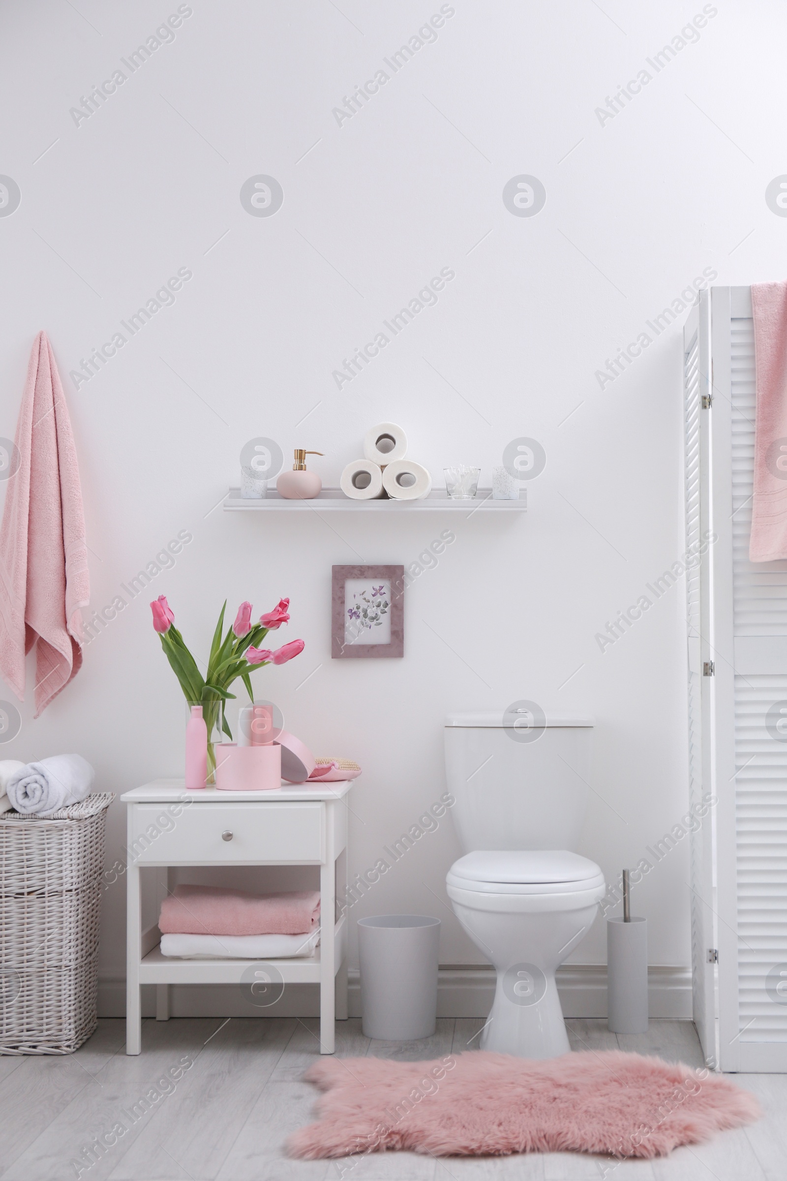 Photo of Interior of stylish bathroom with toilet bowl and decor elements