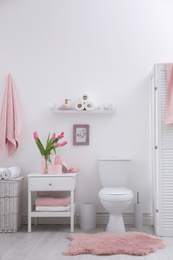 Interior of stylish bathroom with toilet bowl and decor elements