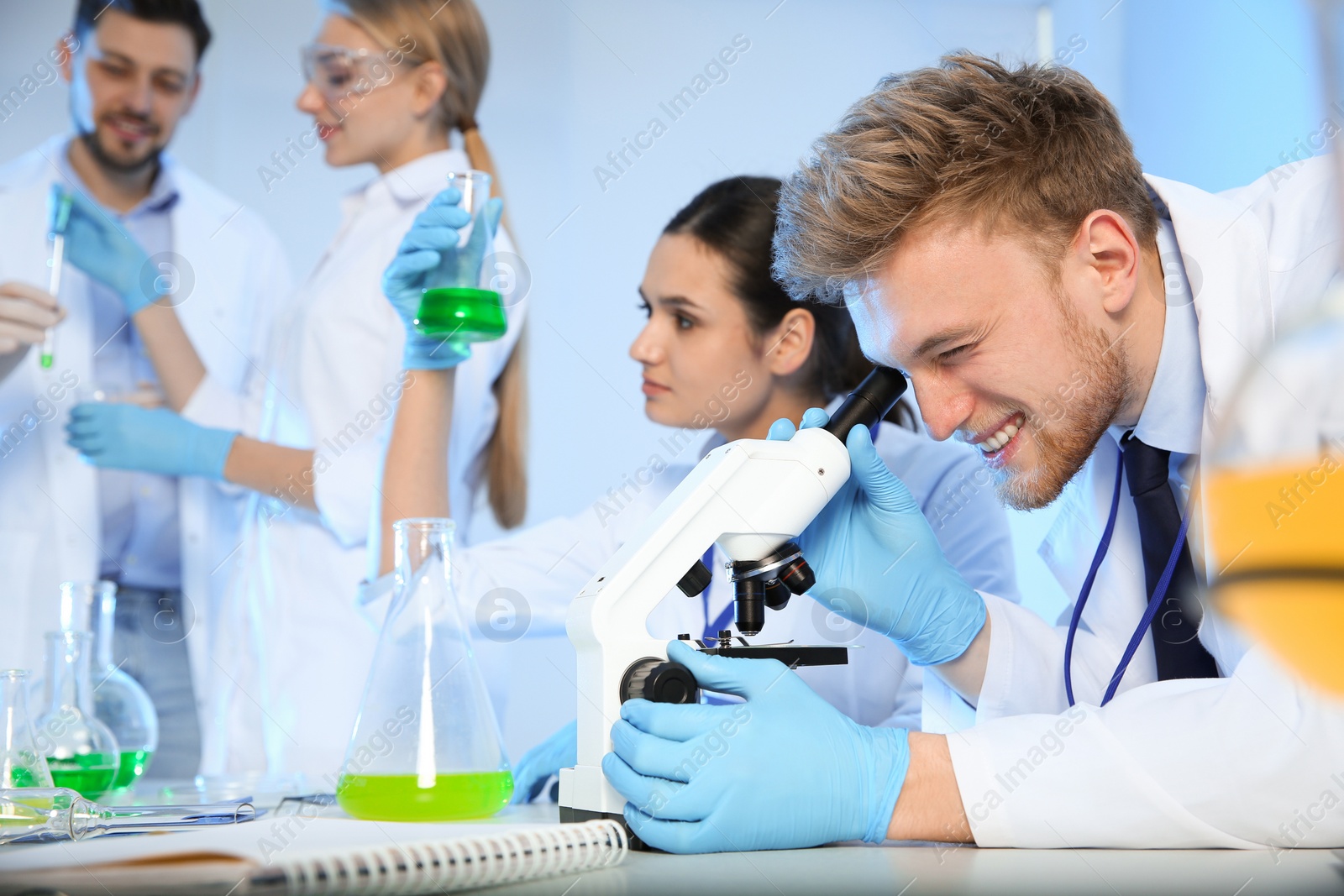 Photo of Group of scientists working in modern chemistry laboratory