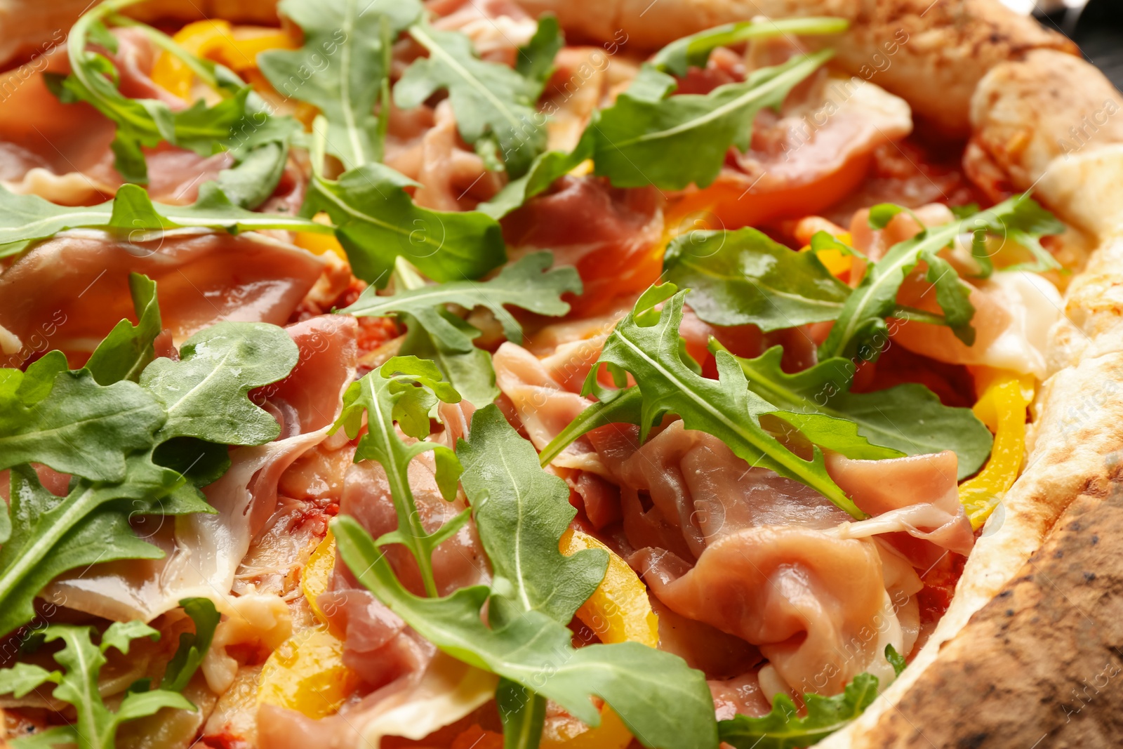 Photo of Tasty pizza with meat and arugula, closeup view