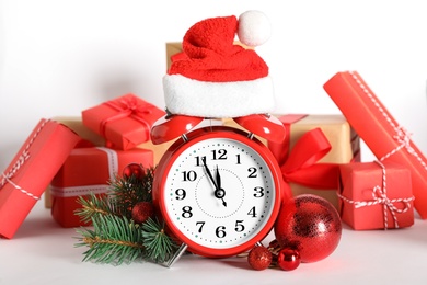 Alarm clock with Christmas decor on white background. New Year countdown
