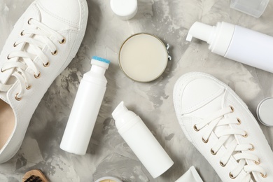 Photo of Flat lay composition with stylish footwear and shoe care accessories on light grey background