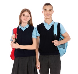 Photo of Portrait of teenagers in school uniform with backpacks on white background