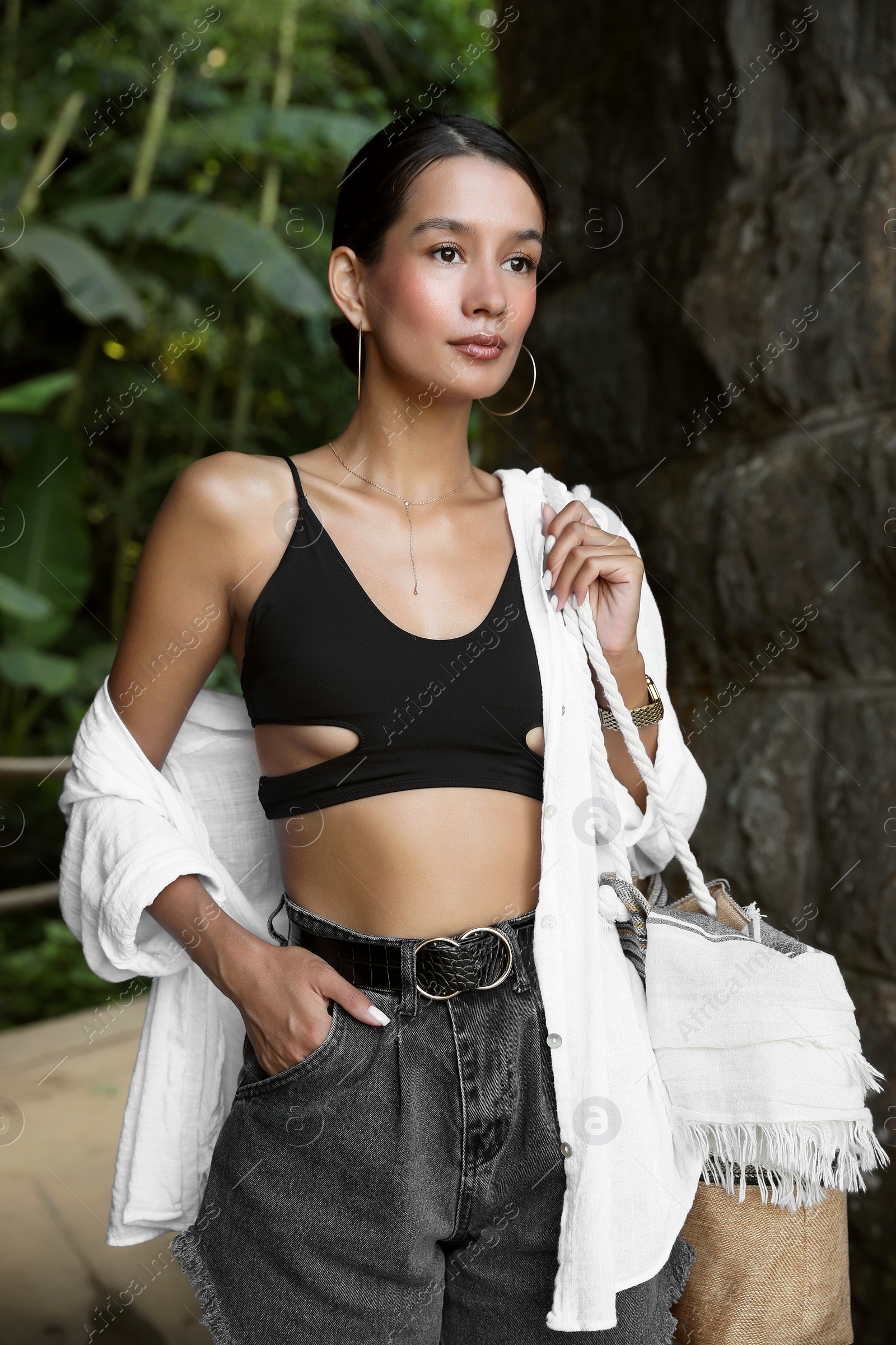 Photo of Beautiful young woman in green tropical park