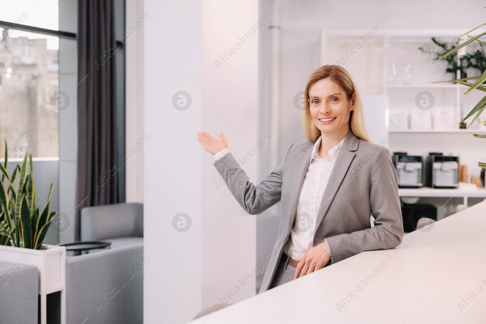 Photo of Female real estate agent indoors. Space for text