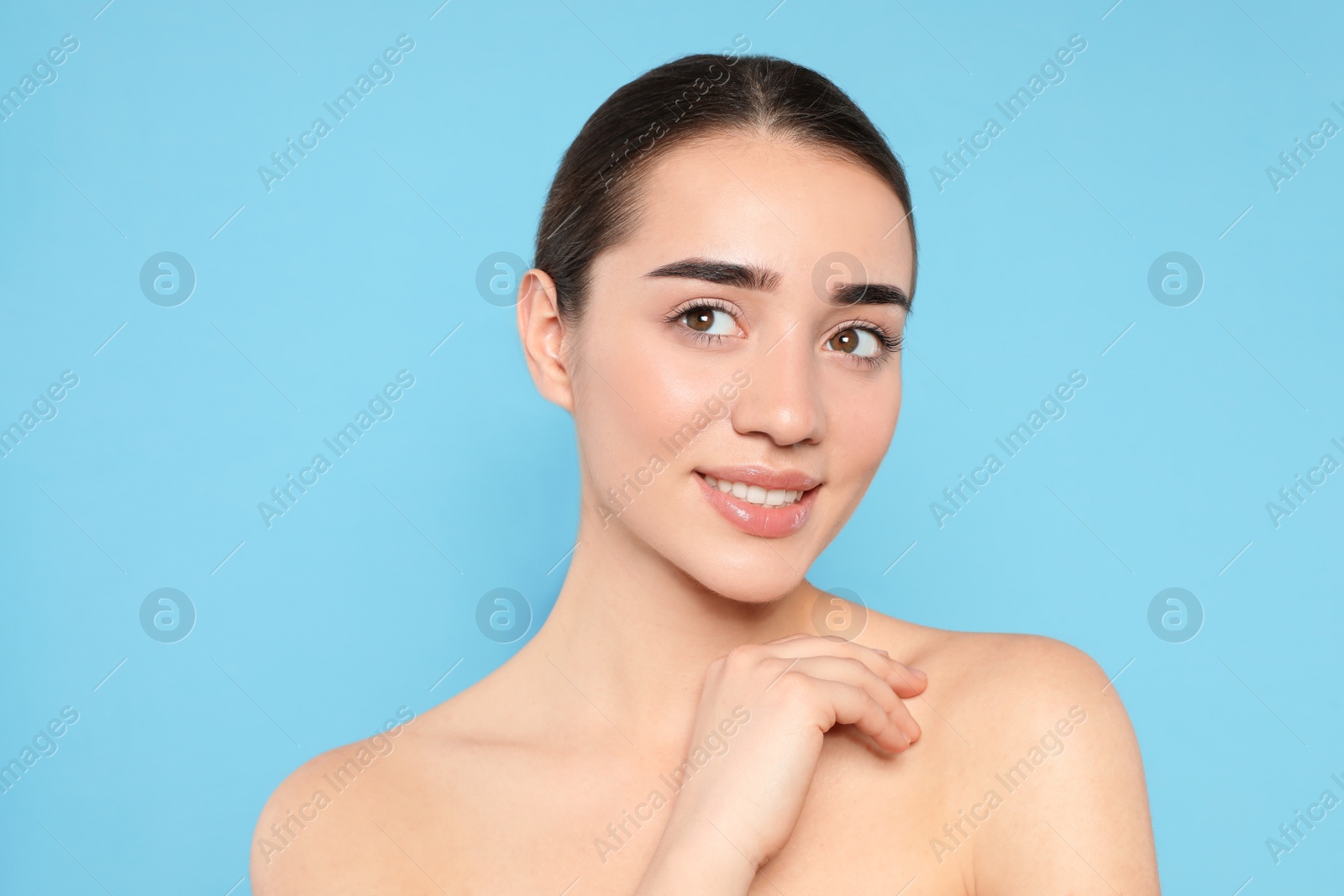 Photo of Portrait of young woman with beautiful face against color background