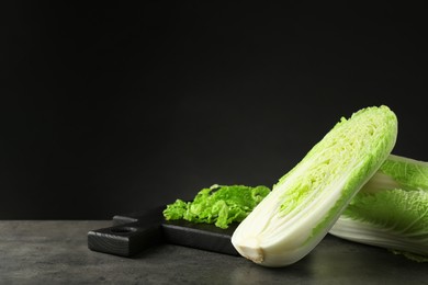 Fresh ripe Chinese cabbages on grey table, space for text