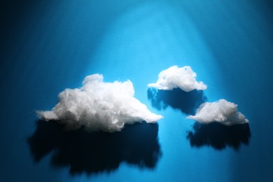 Photo of Clouds made of cotton on blue background