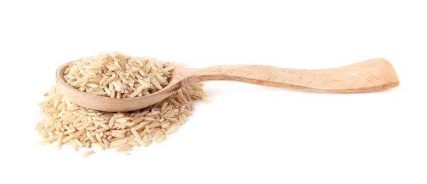 Spoon and uncooked brown rice on white background