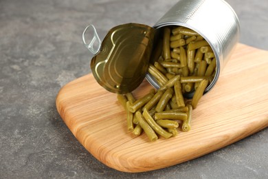 Photo of Canned green beans on grey table, closeup