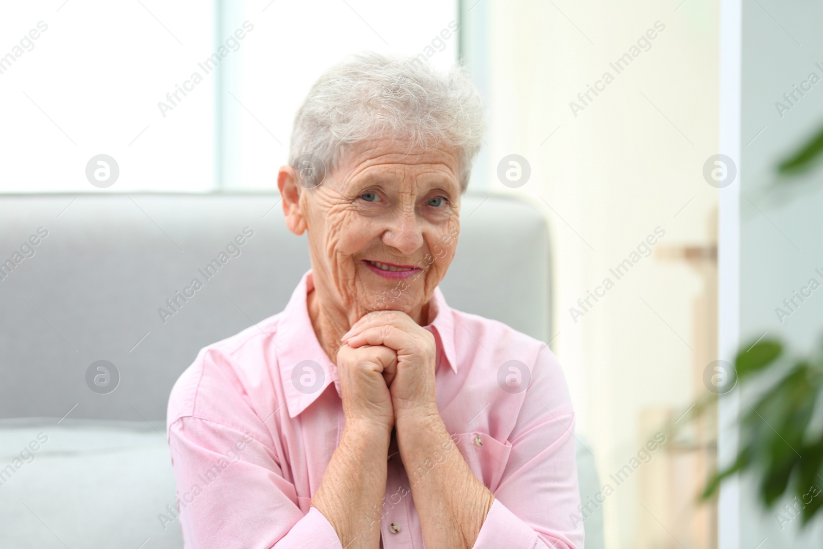 Photo of Portrait of beautiful grandmother in living room