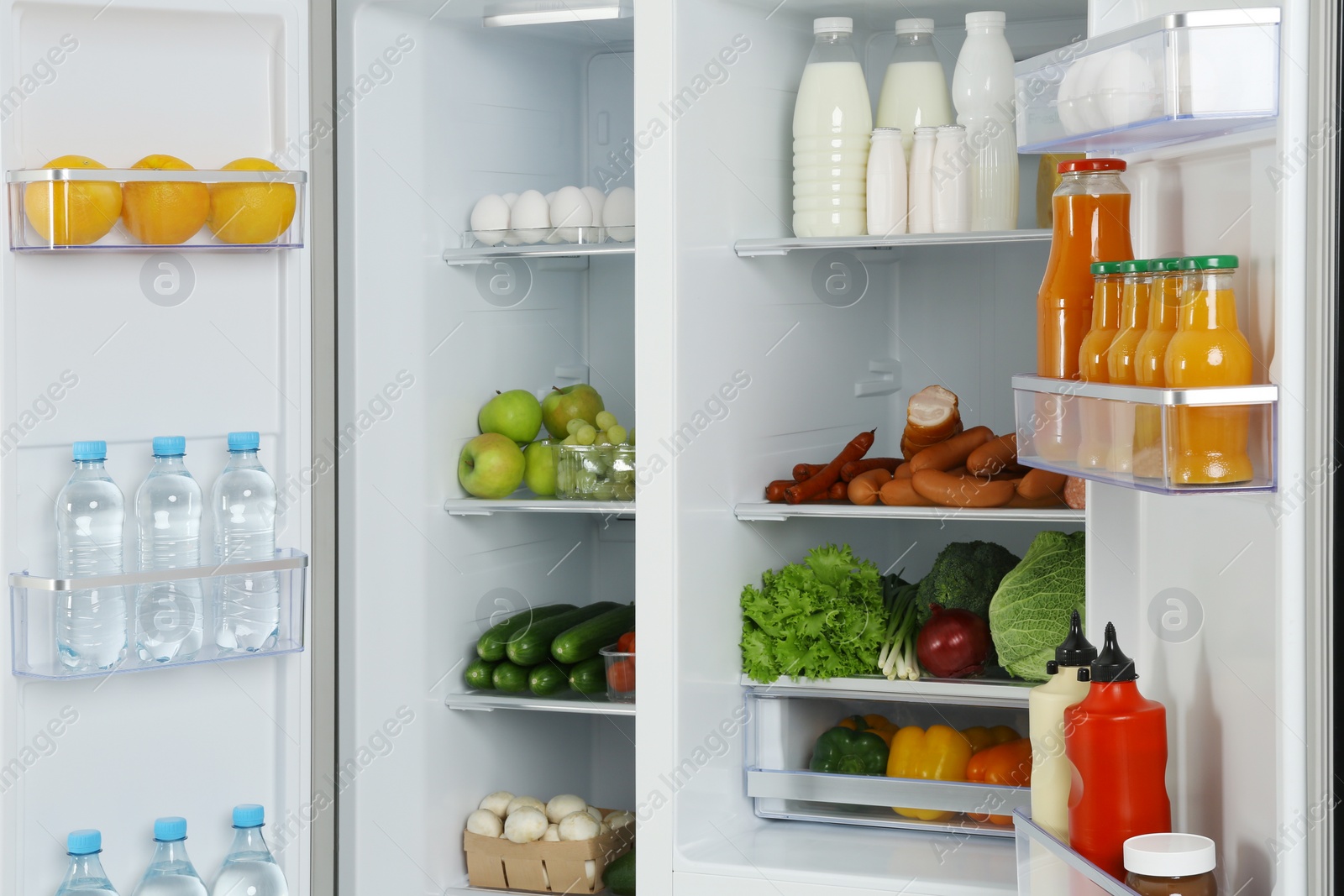 Photo of Open refrigerator full of different fresh products