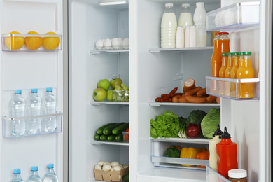 Open refrigerator full of different fresh products