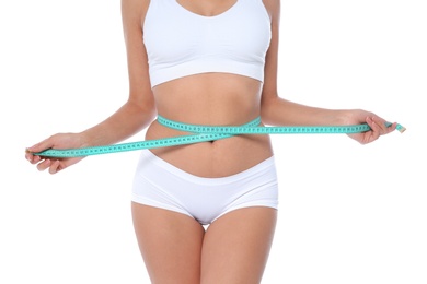 Photo of Slim woman measuring her waist on white background, closeup. Weight loss