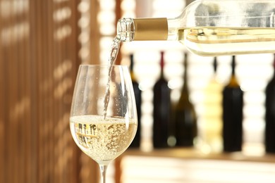 Photo of Pouring wine into glass in restaurant, closeup