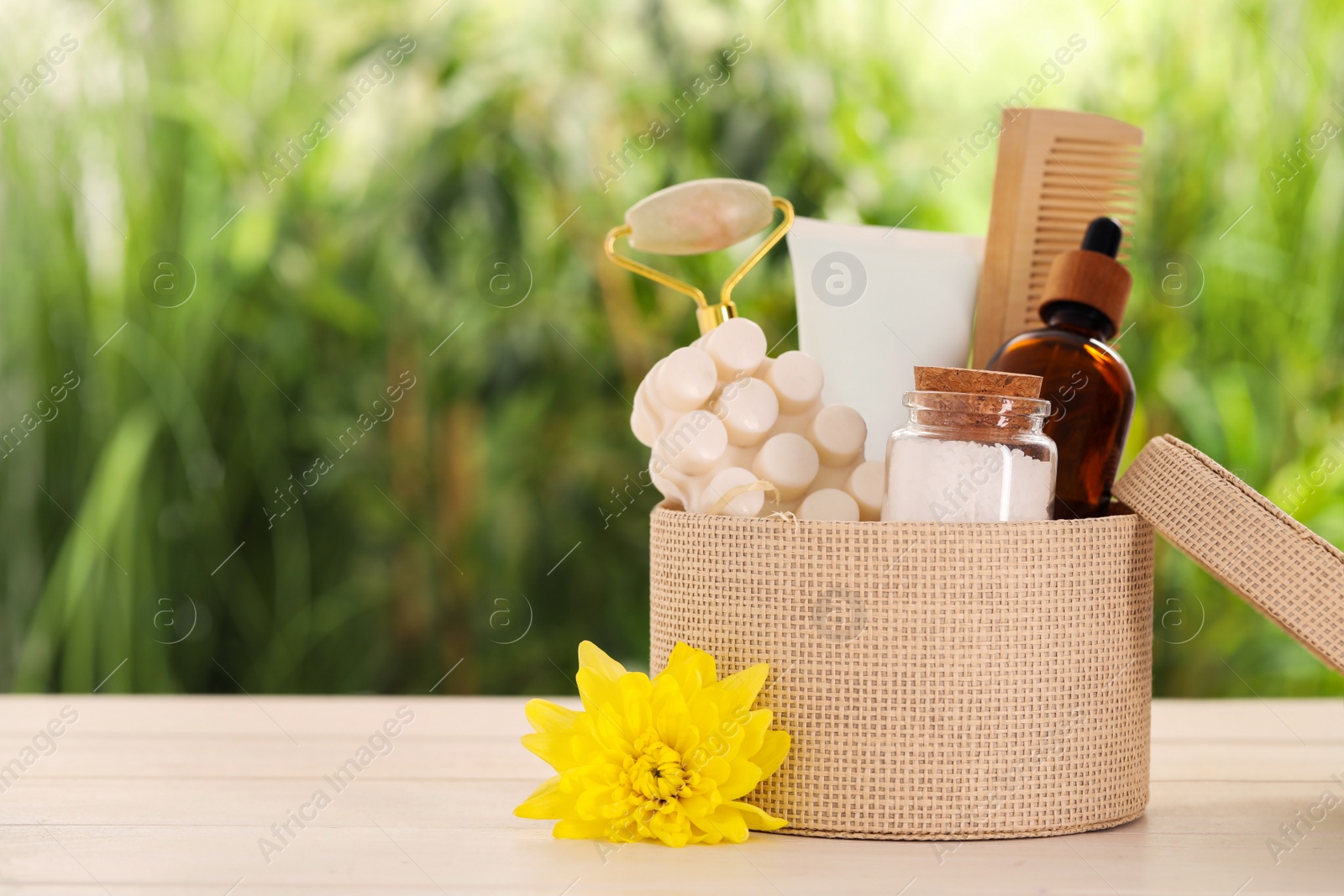 Photo of Spa gift set with different products on white wooden table against blurred background