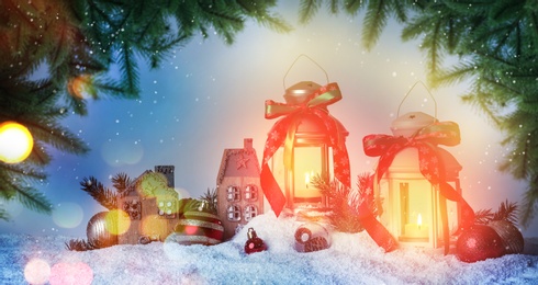 Beautiful composition with vintage Christmas lanterns and festive decorations on snow against color background, banner design. Bokeh effect