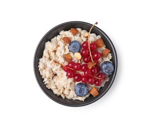 Photo of Ceramic bowl with oatmeal, berries and almonds isolated on white, top view