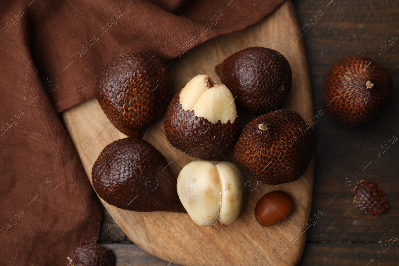 Photo of Fresh salak fruits on wooden table, top view