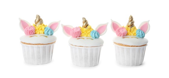 Three cute sweet unicorn cupcakes on white background